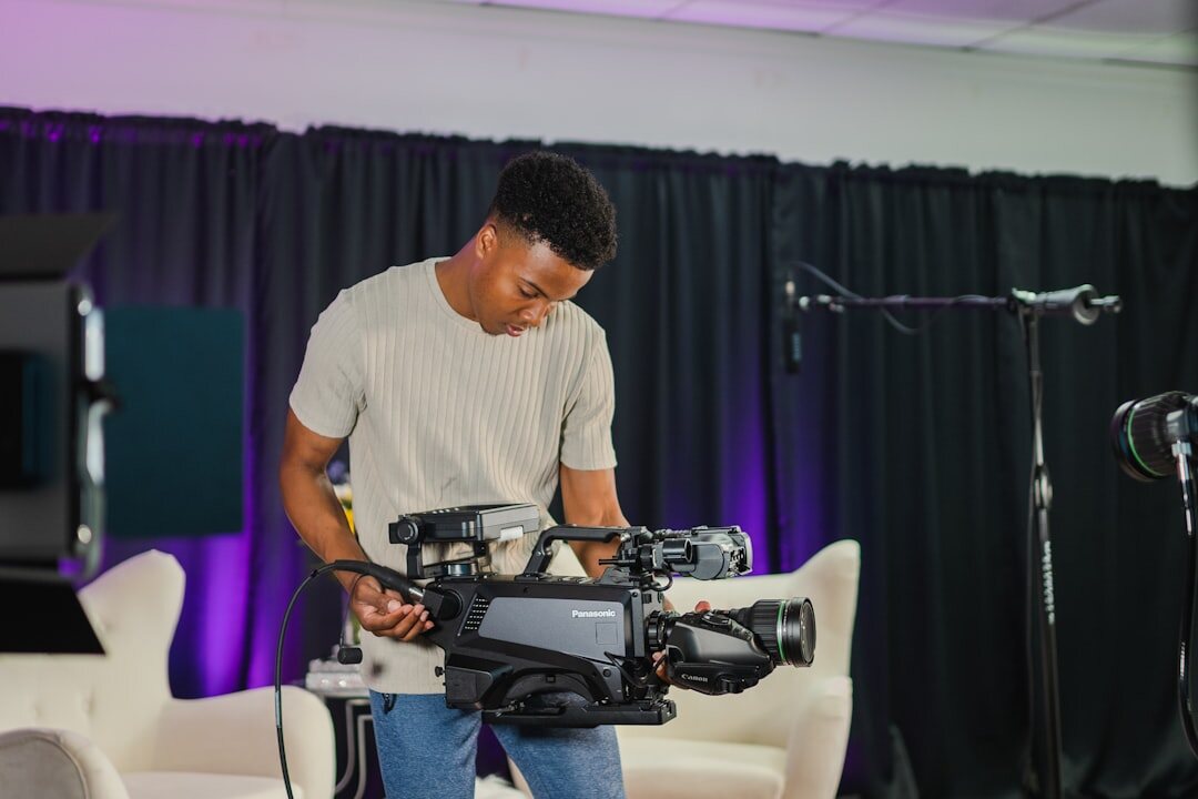 Professional studio camera with teleprompter attached in broadcast studio