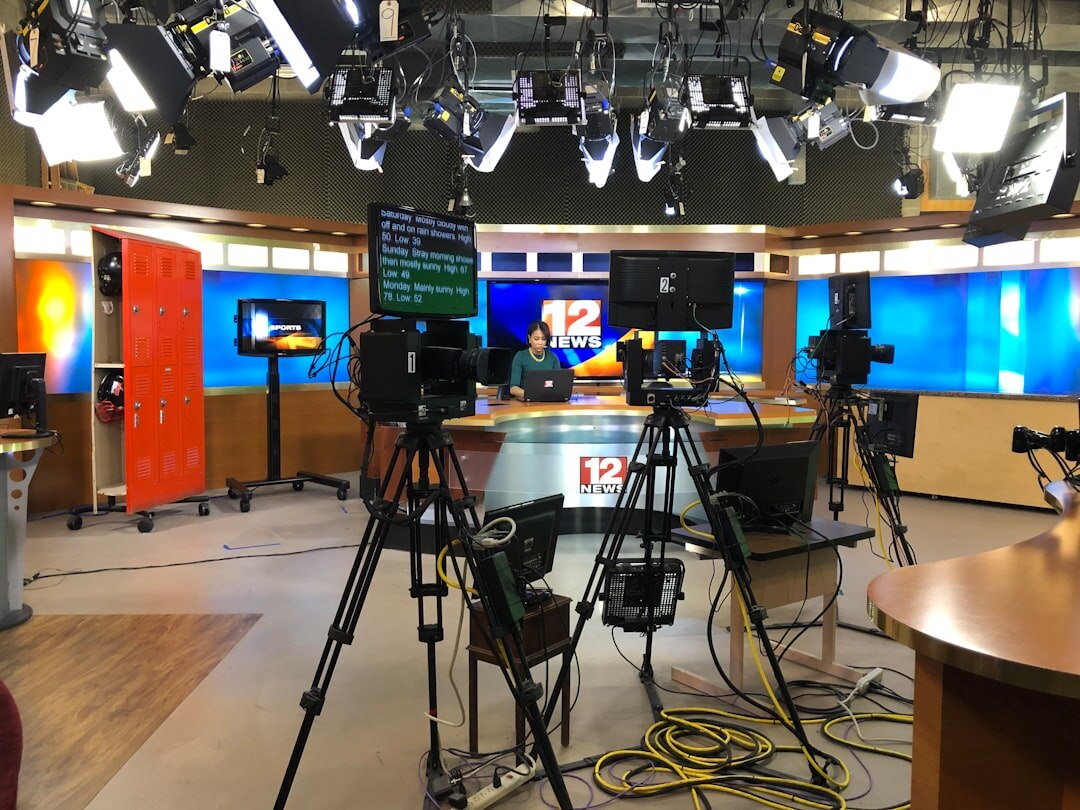 Instructor teaching students in a television studio environment